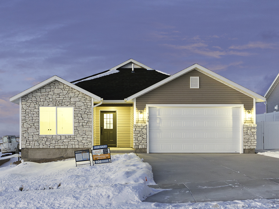 106 Kachina way featuring tan and white siding, black shingles, sleek black hardware and finishes, white speckles countertops, grey and white cabinetry.